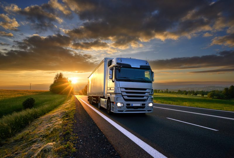 Truck,Driving,On,The,Asphalt,Road,In,Rural,Landscape,At